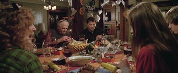 Movie still from “Trust” (2010), directed by David Schwimmer – A group of people sitting around a table with food; Medium shot, High angle