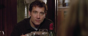 Movie still from “Trust” (2010), directed by David Schwimmer – A person sitting at a table with a glass of wine; Close Up shot, Over the shoulder angle