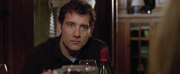 Movie still from “Trust” (2010), directed by David Schwimmer – A person sitting at a table with a glass of wine; Close Up shot, Over the shoulder angle