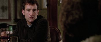 Movie still from “Trust” (2010), directed by David Schwimmer – A man sitting in front of a woman in front of a mirror; Close Up shot, Over the shoulder angle