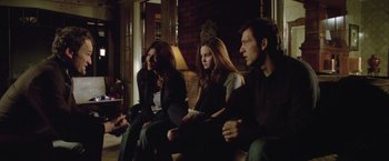 Movie still from “Trust” (2010), directed by David Schwimmer – A group of people sitting in a room; Medium shot, Over the shoulder angle