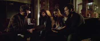 Movie still from “Trust” (2010), directed by David Schwimmer – A group of people sitting in a living room together; Medium shot, High angle