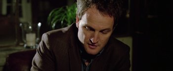 Movie still from “Trust” (2010), directed by David Schwimmer – A person wearing a suit and tie; Close Up shot, Over the shoulder angle