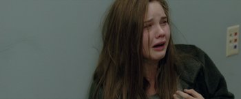 Movie still from “Trust” (2010), directed by David Schwimmer – A young girl with long brown hair is crying; Close Up shot, High angle