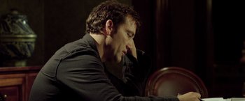 Movie still from “Trust” (2010), directed by David Schwimmer – A person sitting at a table; Close Up shot, Low angle