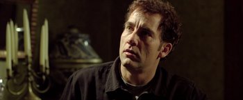 Movie still from “Trust” (2010), directed by David Schwimmer – A person wearing a black shirt; Close Up shot, Low angle