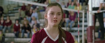 Movie still from “Trust” (2010), directed by David Schwimmer – A young girl is standing in front of a group of people; Close Up shot, Low angle