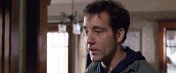 Movie still from “Trust” (2010), directed by David Schwimmer – A man's face in front of a window; Close Up shot, Low angle