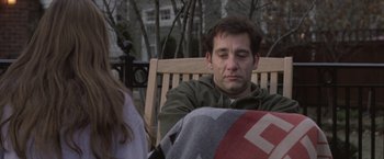 Movie still from “Trust” (2010), directed by David Schwimmer – A man sitting on top of a wooden park bench; Close Up shot, Over the shoulder angle