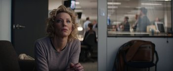 Movie still from “Truth” (2015), directed by James Vanderbilt – A woman sitting in an office looking at the camera; Medium shot, Low angle