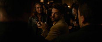 Movie still from “Truth” (2015), directed by James Vanderbilt – A man holding a cell phone while standing next to another man; Close Up shot, Over the shoulder angle