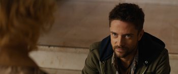 Movie still from “Truth” (2015), directed by James Vanderbilt – A person sitting on a ledge; Close Up shot, Over the shoulder angle