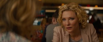 Movie still from “Truth” (2015), directed by James Vanderbilt – A woman sitting at a table in front of other people; Close Up shot, Over the shoulder angle