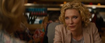 Movie still from “Truth” (2015), directed by James Vanderbilt – A person sitting at a table in a restaurant; Close Up shot, Over the shoulder angle