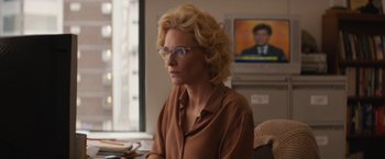 Movie still from “Truth” (2015), directed by James Vanderbilt – A woman sitting in front of a television; Close Up shot, Over the shoulder angle