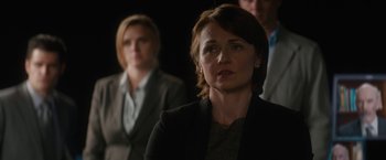 Movie still from “Truth” (2015), directed by James Vanderbilt – A woman standing in front of two other people; Close Up shot, Over the shoulder angle