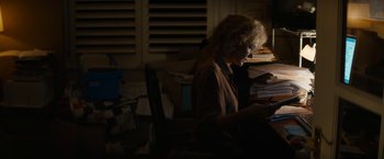 Movie still from “Truth” (2015), directed by James Vanderbilt – An older woman sitting in a chair in the dark; Medium shot, High angle