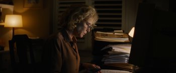 Movie still from “Truth” (2015), directed by James Vanderbilt – A woman in a brown shirt looking at a phone; Medium shot, High angle