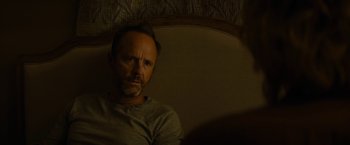 Movie still from “Truth” (2015), directed by James Vanderbilt – A man sitting in a chair looking at the camera; Close Up shot, Over the shoulder angle