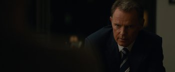 Movie still from “Truth” (2015), directed by James Vanderbilt – A man in a suit and a tie; Close Up shot, Over the shoulder angle