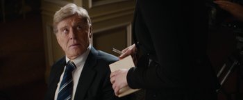 Movie still from “Truth” (2015), directed by James Vanderbilt – A man in a suit and a woman in a black jacket; Close Up shot, Over the shoulder angle