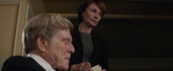 Movie still from “Truth” (2015), directed by James Vanderbilt – A woman wearing headphones listening to a lecture; Close Up shot, Over the shoulder angle