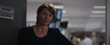 Movie still from “Truth” (2015), directed by James Vanderbilt – A person with short hair wearing a necklace; Close Up shot, Over the shoulder angle