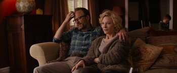 Movie still from “Truth” (2015), directed by James Vanderbilt – A man and a woman sitting on a couch together; Medium shot, Over the shoulder angle
