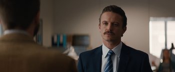 Movie still from “Truth” (2015), directed by James Vanderbilt – A person wearing a suit and tie; Close Up shot, Over the shoulder angle