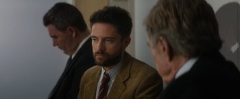 Movie still from “Truth” (2015), directed by James Vanderbilt – A person wearing a suit and a tie; Close Up shot, Over the shoulder angle