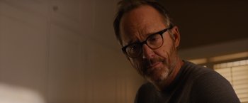 Movie still from “Truth” (2015), directed by James Vanderbilt – A person wearing glasses; Close Up shot, Over the shoulder angle