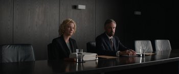Movie still from “Truth” (2015), directed by James Vanderbilt – A man and a woman sitting in front of a wooden table; Medium shot, Low angle