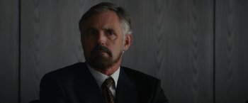 Movie still from “Truth” (2015), directed by James Vanderbilt – A person wearing a suit and tie; Close Up shot, Over the shoulder angle