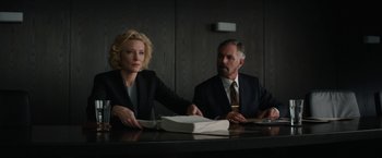 Movie still from “Truth” (2015), directed by James Vanderbilt – A man and a woman sitting at a table with papers; Medium shot, Low angle