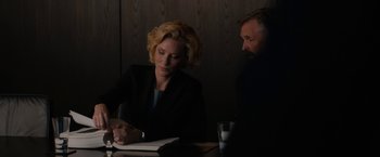 Movie still from “Truth” (2015), directed by James Vanderbilt – A woman sitting at a table writing on a piece of paper next to a man; Medium shot, Over the shoulder angle