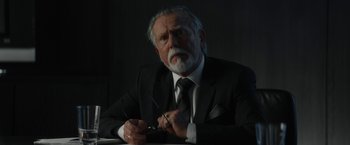 Movie still from “Truth” (2015), directed by James Vanderbilt – An older man in a suit and tie holding a pair of scissors; Close Up shot, Low angle