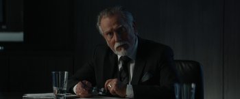 Movie still from “Truth” (2015), directed by James Vanderbilt – An older man in a black suit and white tie; Close Up shot, Low angle