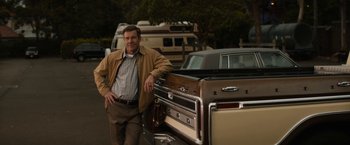 Movie still from “Truth” (2015), directed by James Vanderbilt – A man standing next to an old truck; Medium shot, Low angle