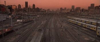 Movie still from “Tsotsi” (2005), directed by Gavin Hood – A train yard with many trains on it's tracks; Extreme Wide shot, High angle