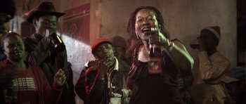 Movie still from “Tsotsi” (2005), directed by Gavin Hood – A group of people standing next to each other; Close Up shot, Low angle