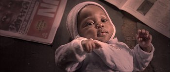 Movie still from “Tsotsi” (2005), directed by Gavin Hood – A baby wearing a hood; Close Up shot, High angle
