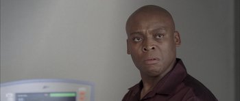 Movie still from “Tsotsi” (2005), directed by Gavin Hood – A man with a bald head is looking at the camera; Close Up shot, Low angle