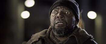 Movie still from “Tsotsi” (2005), directed by Gavin Hood – A person wearing a hat and a jacket; Close Up shot, Low angle