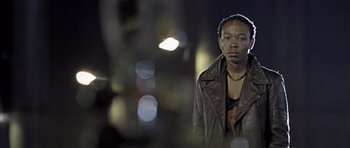 Movie still from “Tsotsi” (2005), directed by Gavin Hood – A man wearing a leather jacket and headphones; Close Up shot, Low angle