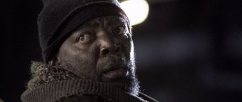 Movie still from “Tsotsi” (2005), directed by Gavin Hood – A person wearing a hat; Close Up shot, Low angle