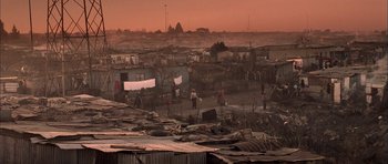 Movie still from “Tsotsi” (2005), directed by Gavin Hood – A group of people standing on top of a dirt field; Extreme Wide shot, High angle