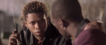 Movie still from “Tsotsi” (2005), directed by Gavin Hood – A man in a leather jacket talking to another man in a leather jacket; Close Up shot, Over the shoulder angle
