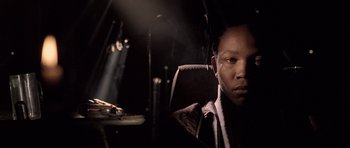 Movie still from “Tsotsi” (2005), directed by Gavin Hood – A man sitting in a car in the dark; Close Up shot, Low angle