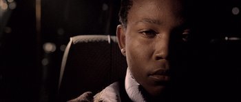 Movie still from “Tsotsi” (2005), directed by Gavin Hood – A person's face in a car seat; Close Up shot, Low angle