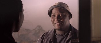 Movie still from “Tsotsi” (2005), directed by Gavin Hood – A person wearing a hat; Close Up shot, Low angle